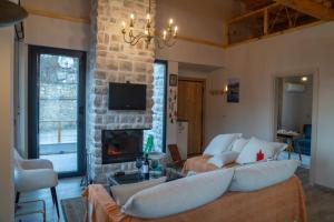 a living room with a couch and a fireplace at Endless View Orma Guesthouse in Orma