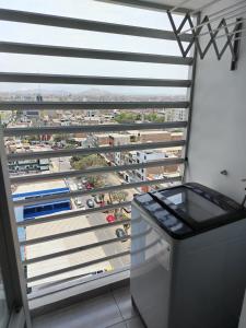 a balcony with a view of a parking lot at Agradable, en el centro y con cochera in Trujillo