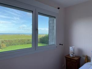 Postel nebo postele na pokoji v ubytování Maison vue sur mer