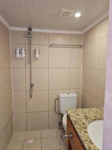 a bathroom with a shower and a toilet and a sink at Maria Mulata Apartments in Noord +52 photos