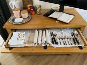a table with a tray of utensils on it at The chalet in Chandlers Ford