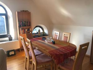 a dining room with a wooden table and chairs at Neu renovierte Wohnung in Alter Schule in Hattgenstein