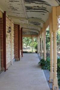 an empty porch of a house with columns at Cockburn House in Jamestown
