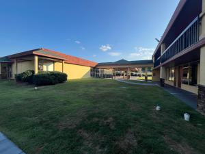 a large yard next to a school building at Budgetel Inn - Phenix City in Phenix City