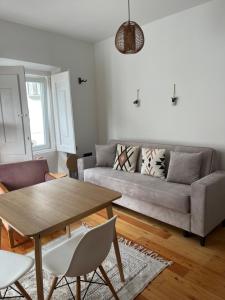 a living room with a couch and a table at Casa dos Mouros in Évora
