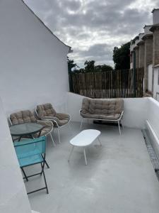a balcony with couches and chairs on a building at Casa dos Mouros in Évora