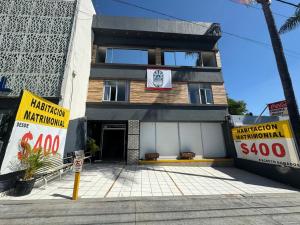 a building with signs in front of it at Hotel Urban Matamoros in Tepatitlán de Morelos