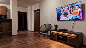 a living room with a flat screen tv on a wall at Rebeka Luxury Apartment in Tryavna