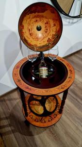 a serving table with wine glasses and a candle at Rebeka Luxury Apartment in Tryavna
