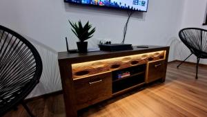 a wooden entertainment center with a tv in a living room at Rebeka Luxury Apartment in Tryavna