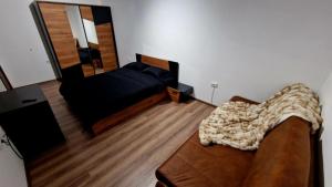 a living room with a couch and a mirror at Rebeka Luxury Apartment in Tryavna +26 photos