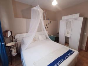 a white bed with a canopy in a room at Ca l'Herminia in Gironella +20 photos