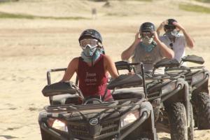 a group of people riding atvs on the beach at Excepcional One bedroom Suite in Cabo San Lucas