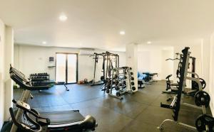 a gym with several tread machines in a room at Excepcional One bedroom Suite in Cabo San Lucas