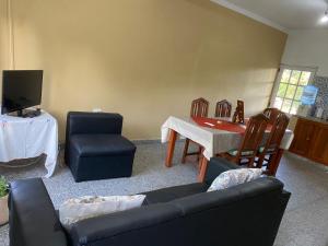 a living room with a couch and chairs and a table at Casa en La Puntilla in Belén