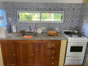 a kitchen with a sink and a stove and a window at Casa en La Puntilla in Belén +14 photos