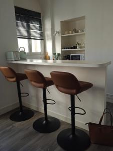 a kitchen with two bar stools in front of a counter at Gare Montparnasse,gorgeous1 bedroom,close to Eiffel tour,center , stuning place in Paris