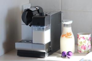 a coffee maker and a bottle of milk on a counter at The Sleeping Lady Private Retreat in Porongurup