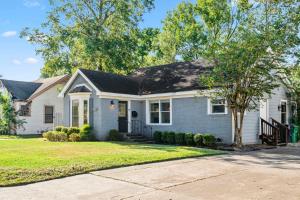 a white house with a black roof at Charming Houston Home Near Med Center & University of Houston in Houston