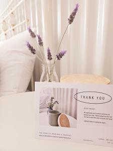 a card with a vase with purple flowers on a table at The Barn, Nungurner in Nungurner