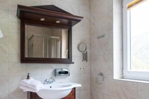 a bathroom with a sink and a mirror at International House Sölden Studio mit Balkon ZW 2 in Sölden