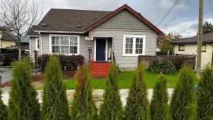 a house with a bunch of trees in front of it at ALL NEW 2BR Loft in Chilliwack