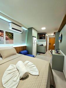 a bedroom with a bed with a towel on it at O Melhor do Cupe no Cupe Exclusive COM e SEM Piscina privativa by HM in Porto De Galinhas