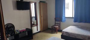 Ένα ή περισσότερα κρεβάτια σε δωμάτιο στο Hotel Eje Cafetero
