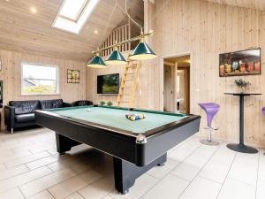 a living room with a pool table in it at 5 star holiday home in Idestrup in Marielyst
