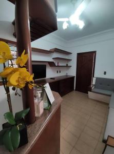 a kitchen with a counter with yellow flowers on it at Casa Nivaldo Ribeiro in Rio Verde