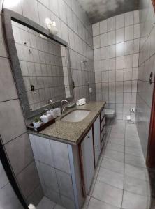 a bathroom with a sink and a mirror at Casa Nivaldo Ribeiro in Rio Verde