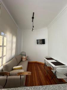 a living room with a couch and a table at 120 años de historia a 1 cuadra del Obelisco in Buenos Aires