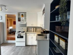 een keuken met witte kasten en een blauwe muur bij Stylish 1-BDRM Prime Location, Unit 2 in Halifax