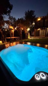 a swimming pool with blue water at night at Casa.dovale in Caeté-Açu