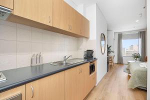 a kitchen with a sink and a counter top at Small Moments in Perth