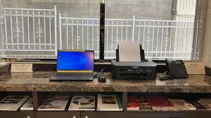 a desk with a laptop computer and a printer at Toyoko Inn Marugame Ekimae in Marugame