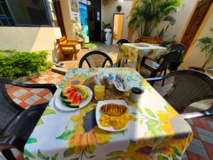 a table with a plate of breakfast food on it at HOSTAL SAN MARINO in Manta +29 photos