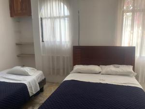 Postel nebo postele na pokoji v ubytování Veranera Hostal