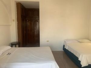 Postel nebo postele na pokoji v ubytování Veranera Hostal