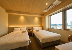Postel nebo postele na pokoji v ubytování Hotel and Spa Gift TAKAYAMA