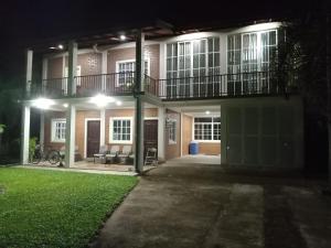 a large house at night with a lawn in front of it at Villa Shendel in Gampaha