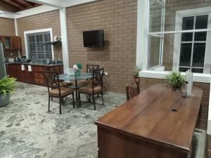 a patio with a table and chairs and a tv at Villa Shendel in Gampaha