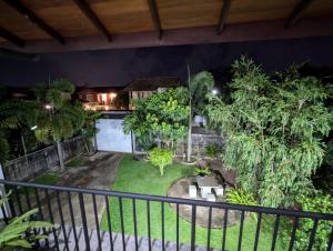 a view of a garden from a balcony at night at Villa Shendel in Gampaha +5 photos