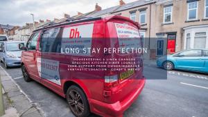 a red van parked on the side of a street at Dwellcome Home Ltd 2 DOUBLE Bedroom 3 Bed Apt, Fast WIFI, Free Street Parking, Ideal for Long Term Contractor, etc Stays, Regular Housekeeping Option, 10 min Walk from Beach and Metro 15-20 min Drive to Nissan & Newcastle - See our Site for Assurance in South Shields