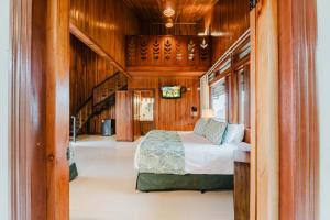 a bedroom in a boat with a bed and a staircase at Hotel Heliconia - Monteverde in Monteverde Costa Rica