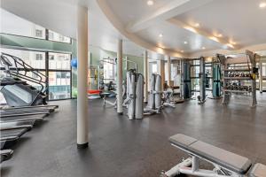 a gym with a lot of treadmills and machines at Modern Comfort in LA Free Parking&10 Min To Cedars in Los Angeles