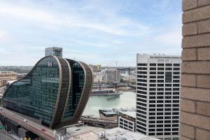 a view of a city with buildings and a river at Harbour Views, Fireworks & Secure Parking in Sydney