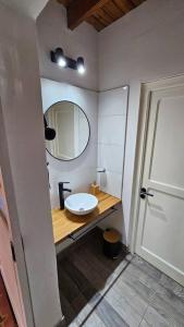 a bathroom with a sink and a mirror at Antigua casa de bodega pax 4 in Maipú +17 photos