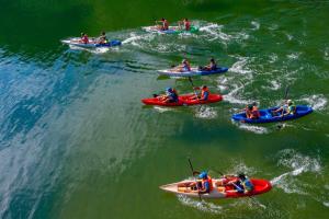 a group of people in boats in the water at Cat Ba Madame Duyen Hotel in Cat Ba
