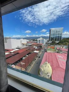 a view of a city street from a window at San Jose Downtown Suites in San José